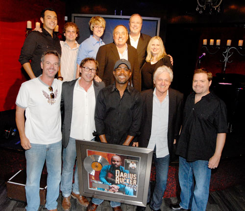 Photo 2: (Top Row L-R) Charles Vegara, (McGhee Entertainment), Jason Hauser (McGhee Entertainment), Melanie Wetherbee (McGhee Entertainment), Doc McGhee (McGhee Entertainment), Mike Dungan (President/CEO Capitol Records Nashville) & Cindy Mabe (SVP Marketing Capitol Records Nashville)  (Bottom Row L-R): Steve Hodges (SVP Promotion Capitol Records Nashville), Scott McGhee (McGhee Entertainment), Rucker, Frank Rand (McGhee Entertainment), & Frank Rogers (Learn to Live Producer).   