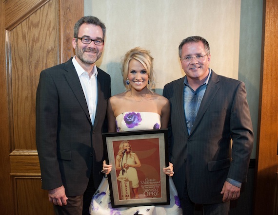 Pictured (L-R): Steve Buchanan/Excecutive Vice President of Opry Entertainment Group, Carrie, Pete Fisher/ Opry President and General Manager with commemorative 5th Opry anniversary printPhoto: Joel Dennis