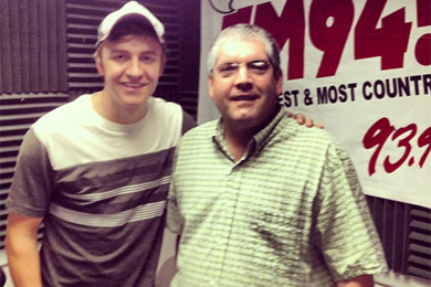 YN Records Tyler Barham (L)recently visited WMEVs Lynn Rutledge (R) in promotion of his No. 67 single, 17 & Young. 