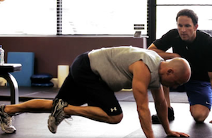 Daniel Meng (right) coaches Kenny Chesney through a workout.