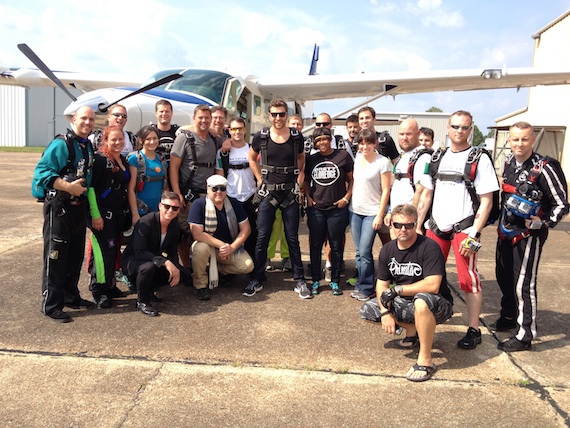 Pictured: Brett Eldredge with USA Todays Brian Mansfield, TV/radio personality Storme Warren, AXS Lives Ashley Eicher, friends, family, management, WMN staff, and other lucky jumpers just prior to his first skydive in celebration of his first No. 1 single Dont Ya.