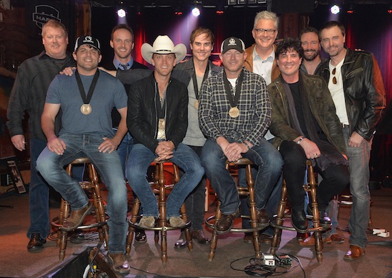 ( l-r): ASCAP's Mike Sistad, This Music's Rusty Gaston, co-writer Ross Copperman, BMI's Perry Howard, Sony ATV Music Publishing Josh Van Valkenburg, and producer Jeremy Stover; (front row, l-r): co-writer Rhett Akins, Justin Moore, co-writer Ben Hayslip, and Big Machine Label Group's Scott Borchetta