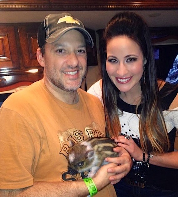 Pictured: Chelsea Bain (r.) visits with NASCAR Sprint Cup great Tony Stewart (l.) and his new pet piglet Pork Chop in Stewarts motor coach prior to the final race of the NASCAR season at Homestead-Miami Speedway on Sunday.