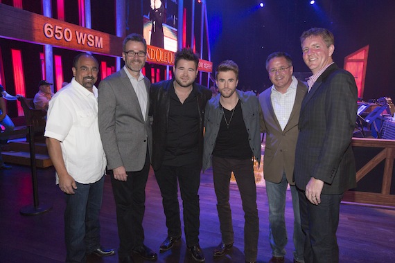 Pictured side stage at the Grand Ole Opry (l-r):  Sony Music Nashville Marketing Sr VP Paul Barnabee; Opry Entertainment Group President Steve Buchanan; Zach and Colton Swon; Grand Ole Opry VP/GM Pete Fisher; and Hill Entertainment Group President Greg Hill. (photo 2 credit:  Chris Hollo)