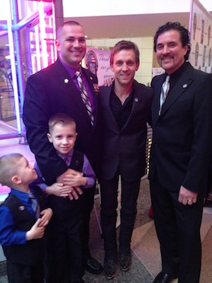 Pictured: Justin Moore and Scott Borchetta pose with Your Heroes Name Here honoree Samuel Deeds and his two sons.