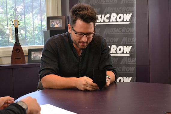 Chris DeStefano accepts a MusicRow Challenge Coin for "Somethin' Bad."