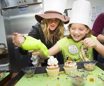 The Bobby Bones Show co-host Amy decorates cupcakes with a patient at St. Jude Childrens Research Hospital in Memphis, Tenn.