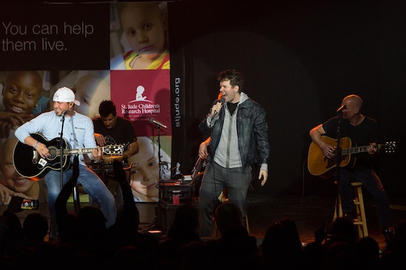 Bobby  Bones and Jason Aldean on stage.