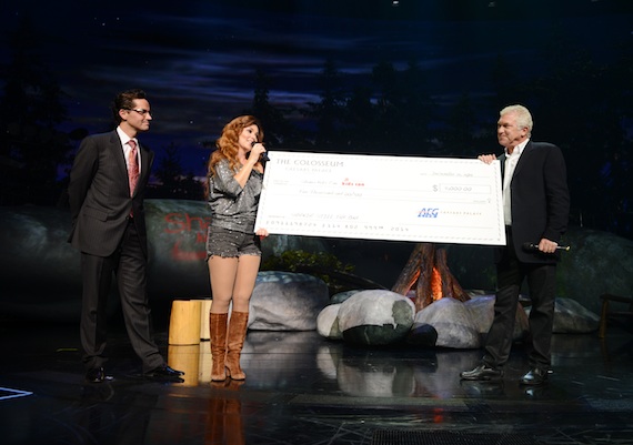 General Manager of Caesars Palace Sean McBurney (L) and President of Global Touring with AEG Live John Meglen (R) present a check to Shania Twain  for her Shania Kids Can Foundation during her final performance of Shania: Still The One at The Colosseum at Caesars Palace. (Photo: Denise Truscello/WireImage)