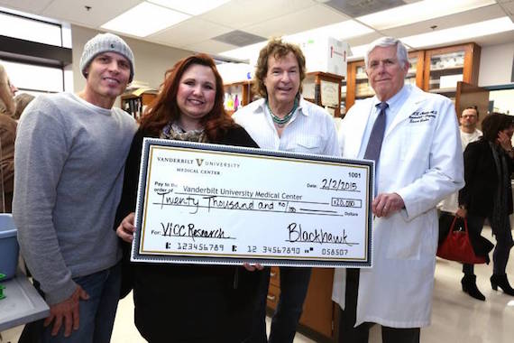 Pictured (L-R): BlackHawk's Dave Robbins, Van Stephenson Memorial Cancer Research Fund volunteer Lori Stefanski, BlackHawk's Henry Paul and Dr. Hal Moses