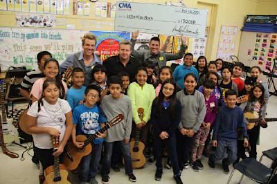 Rascal Flatts (back row, L-R): Joe Don Rooney, Gary LeVox, and Jay DeMarcus visit with students at Miramonte Elementary School. Photo: Courtesy The GreenRoom PR