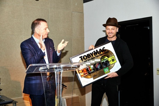 Capitol Christian Music Group President & CEO Bill Hearn presents TobyMac with a plaque to commemorate five studio records RIAA Certified Gold 