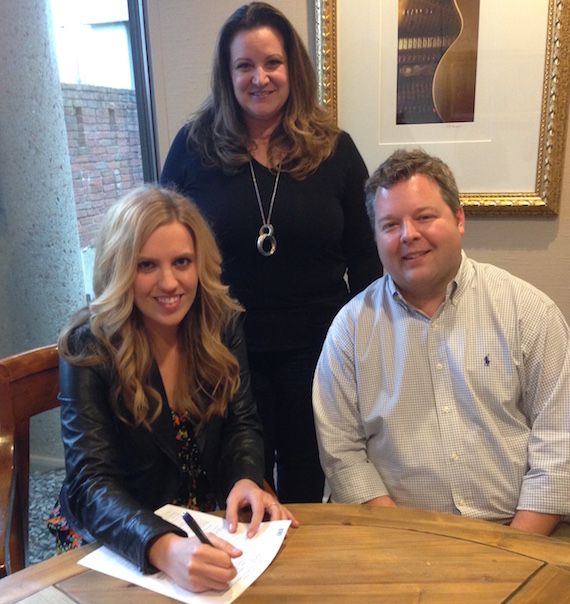  Pictured (seated, L-R): SaraBeth, and BMIs Senior Director, Writer-Publisher Relations Bradley Collins. Standing: Verge Managements Nancy Eckert