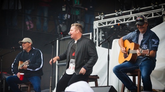  Rascal Flatts' Gary LeVox (middle) performs on stage with songwriters, Neil Thrasher (left) and Kelley Lovelace (right) during Sunday night's performance at Tree Town Music Festival in Forest City, Iowa. (PRNewsFoto/Songs for Sound)