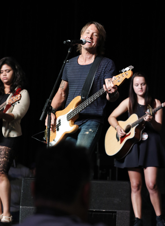 Keith Urban performs with Nashville School of the Arts students Kelly Holmes (left) and Emily Davis (right) during a special appearance on the CMA Close Up stage at AT&T U-verse Fan Fair X during CMA Music Festival Thursday in Nashville. Photo: Donn Jones/CMA