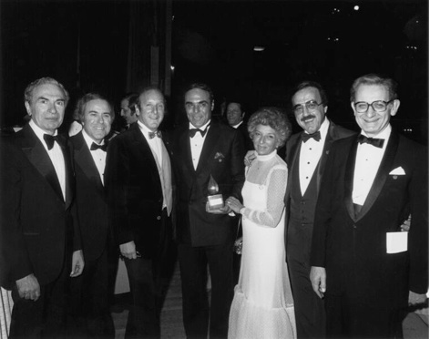 Pictured (L-R): Dave Rothfeld, Floyd Glinert, Clive Davis, Dick Asher, Sheila Asher, Tony Martell and Dr. Jim Holland. Photo Credit: Getty Images) 