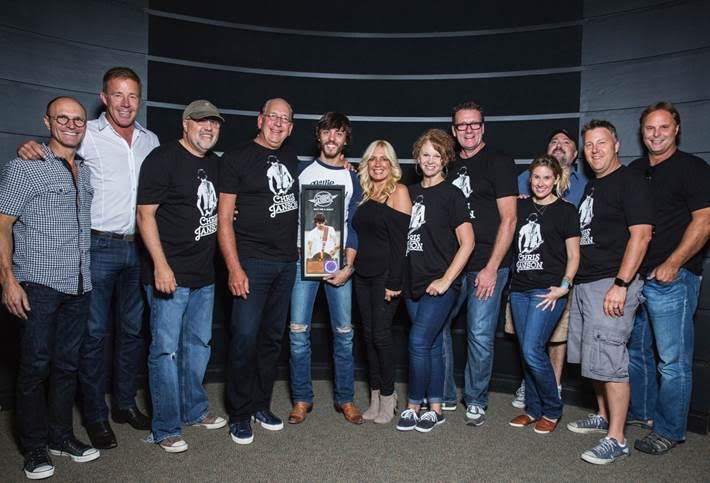 Photo ID: Wes Vause (SVP, Publicity), TK Kimbrell (Manager, TKO Artist Management), Kevin Herring (SVP, Promotion), John Esposito (President & CEO, WMN), Chris Janson, Kelly Janson (Management), Lisa Ray (VP, Brand Management), Peter Strickland (EVP & GM, WMN), Cris Lacy (VP, A&R), Chris Palmer (VP, Promotion), Tom Martens (Dir, National Promotion), Scott Hendricks (SVP, A&R)