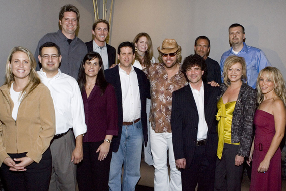 An August 31, 2005 press conference where Scott Borchetta and Toby Keith announced two business entities equally share the same staffing resourcesKeiths Show Dog and Borchettas Big Machine. Pictured (L-R): Front: Darcy Miller-Lashinsky (Secondary Promotion/Promotion Coordinator), Tony Morreale (Southeast Promotion & Marketing), Lisa Owen (West Coast Promotion & Marketing), Zach Horowitz (President and Chief Operating Officer of Universal Music Group), Toby Keith, Scott Borchetta (President - Big Machine Records), Denise Roberts (VP/Promotions) , Sandi Spika-Borchetta (Creative Services); Back: Greg Sax (Southwest Promotion & Marketing), John Zarling (National Promotions & New Media), Suzanne Durham (Northeast Promotion & Marketing), George Nunes (GM/Show Dog), Andrew Kautz (Controller/Office Manager)