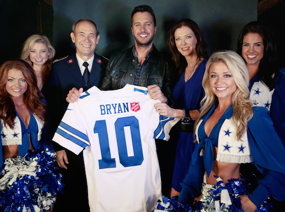 Pictured with Luke Bryan are Charlotte Jones Anderson, executive vice president and chief brand officer for the Dallas Cowboys and former national advisory chairperson for The Salvation Army, Lt. Col. Ron Busroe, and members of the Dallas Cowboys Cheerleaders.