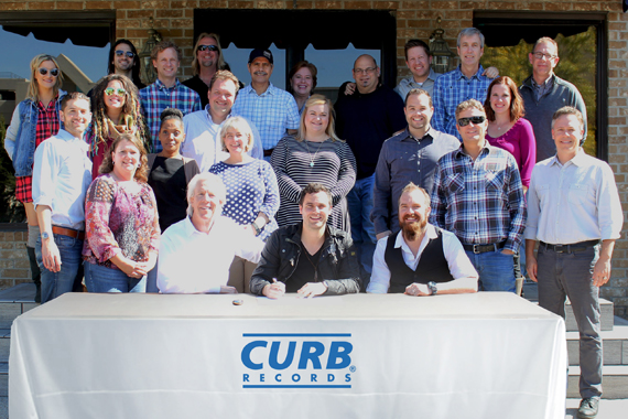 Curb staff with new signee Jackson Michaelson. 