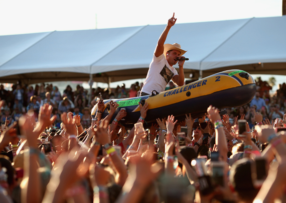 "LAS VEGAS, NEVADA - APRIL 02: Singer Dustin Lynch rides a raft over the crowd while performing at the 4th ACM Party for a Cause Festival at the Las Vegas Festival Grounds on April 2, 2016 in Las Vegas, Nevada. (Photo by Christopher Polk/Getty Images for ACM)"