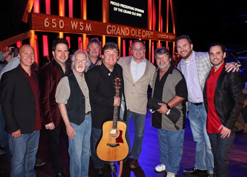 Pictured (L-R): Shenandoahs Shane Chilton, Jamie Michael, Stan Munsey, Donnie Allen, Marty Raybon, Grand Ole Opry's Pete Fisher, Shenandoahs Mike McGuire, SiriusXMs J.R. Schumann, Johnstone Entertainments Cole Johnstone 