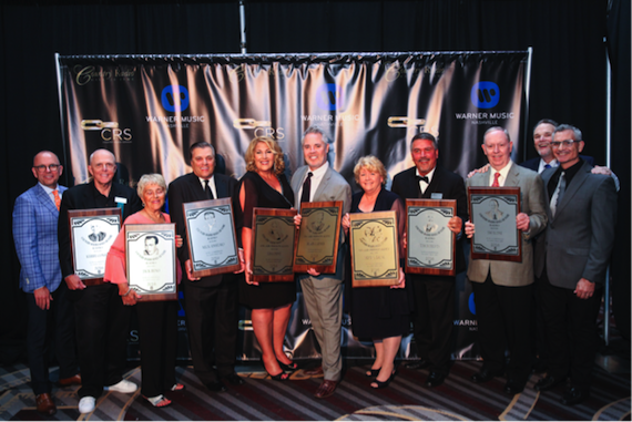 Pictured (L-R): Charlie Morgan, CRB President; Kerby Confer; Bev Reno (accepting on behalf of her late husband, Jack Reno); Mick Anselmo; Lisa Dent; Blair Garner; Dana Schuff; Tim Roberts; Jim Slone; Bill Mayne, CRB Executive Director (back), RJ Curtis, Country Radio Hall of Fame chairman. Photo: Hunter Berry 