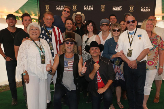 Big & Rich front center, and a cast of musicians and friends join in honoring Medal of Honor recipients recognized on Memorial Day at Camp NASH. Standing middle row, third from left: Colonel Roger Donlon, U.S. Army Special Forces ( Ret.). Standing front row beside John Rich Sgt. Gary Beikirch, U.S. Army Special Forces (Ret.).