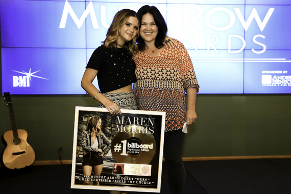 Big Yellow Dogs Carla Wallace (R) surprises her writer Maren Morris (L) with a plaque commemorating a No. 1 country album debut, along with its lead single achieving gold. Photo: Moments By Moser Photography