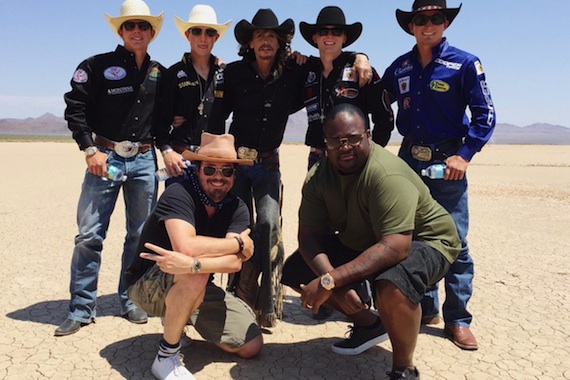 Steven Tyler (Center, back row) poses with members of Professional Bull Riders (PBR)