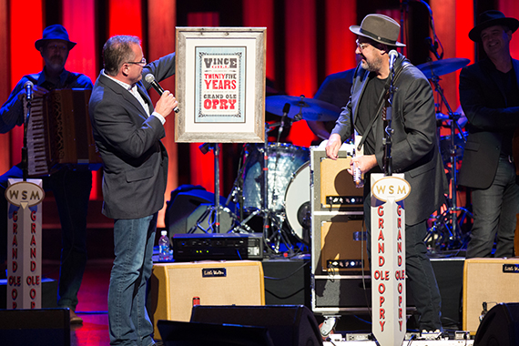 Opry VP/GM Pete Fisher presents beloved Opry member Vince Gill with a commemorative Hatch Show print for his 25th Anniversary celebration.