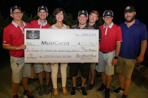 Pictured (L-R): Lee Hendricks (bass), Michael Todd (tour crew), Debbie Carroll of MusiCares, Driver Williams (guitar), Ben Rigby (tour crew), Craig Wright (drums), Jeff Hyde (acoustic guitar). 