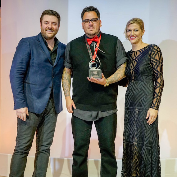 2016 SESAC Songwriter of the Year Award recipient Josh Hoge, the writer of two #1 songs this year, Im Comin Over and Think of You, with RCA Nashville Recording artist Chris Young and SESACs Shannan Hatch. 