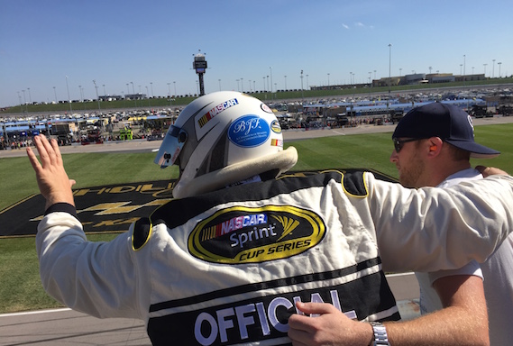 Cole Swindell, honorary starter, prepares to wave the green flag to start the Hollywood Casino 400